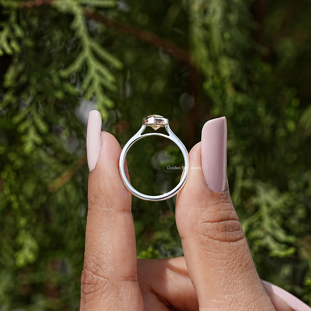 Marquise bezel engagement ring in silver with faceted marquise-cut center stone