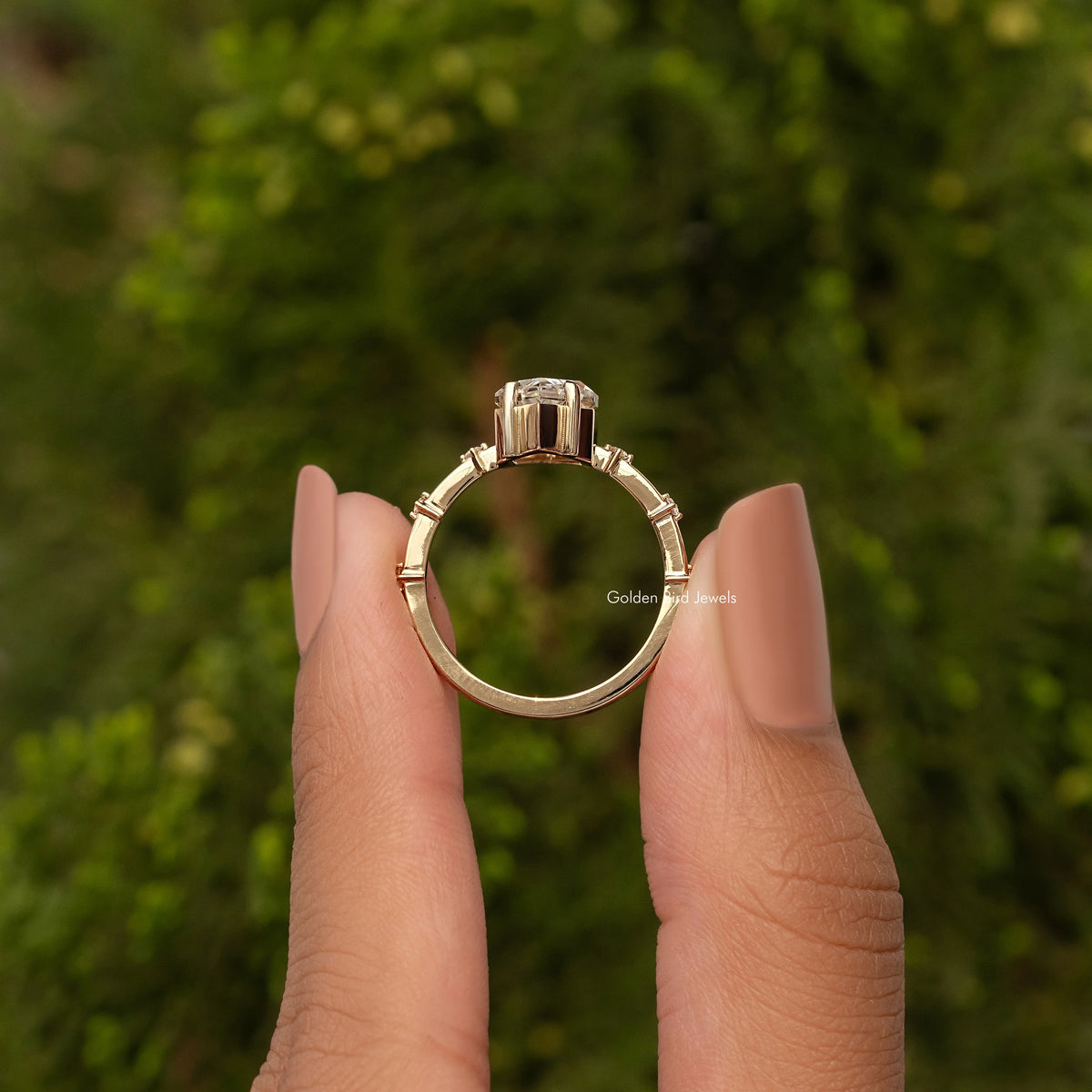 Gold-tone marquise moissanite ring back view with bezel-like center setting