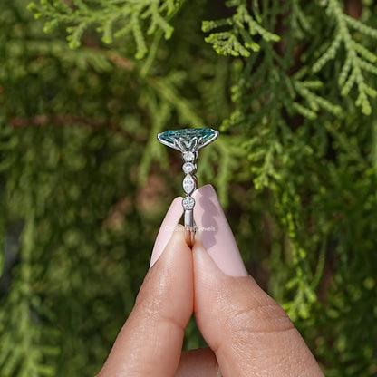 925 sterling silver ring with teal marquise center, prongs, and round halo accents