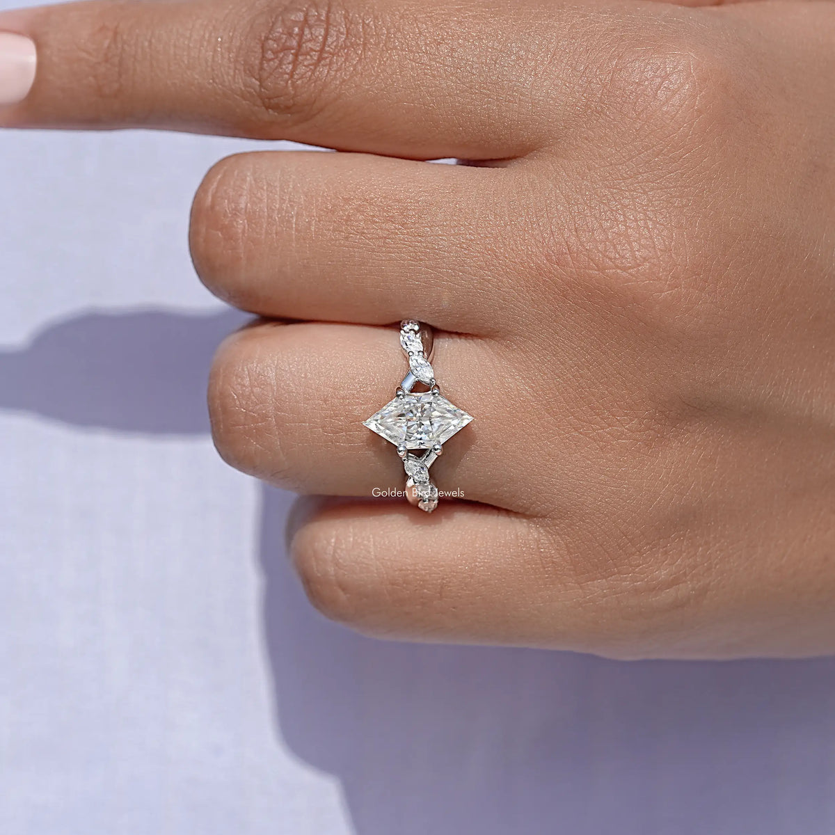 Marquise-cut moissanite floral ring on finger, close-up of the center stone