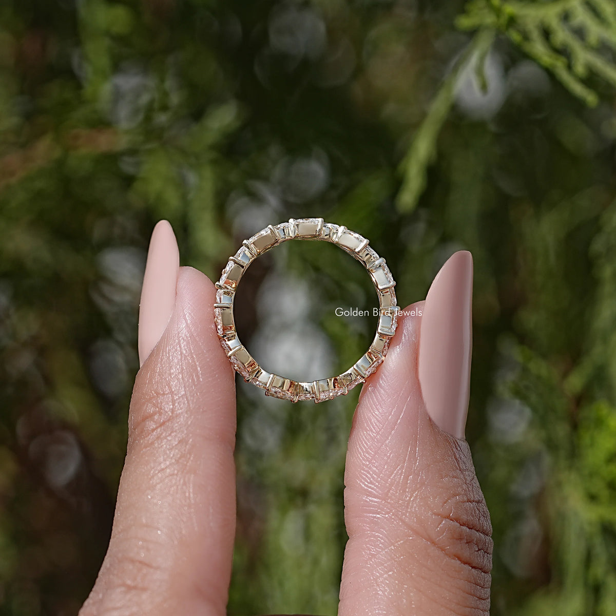 Top view of marquise lab diamond wedding band, gold-tone prong set ring with stones