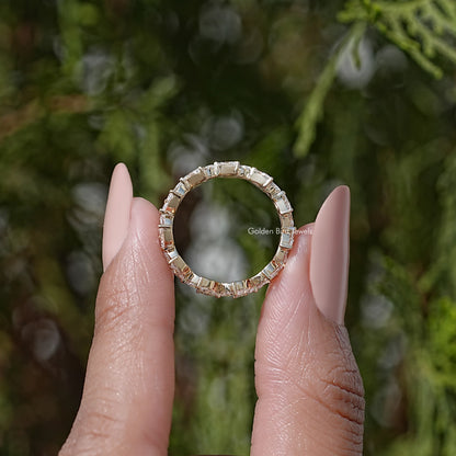 Top view of marquise lab diamond wedding band, gold-tone prong set ring with stones