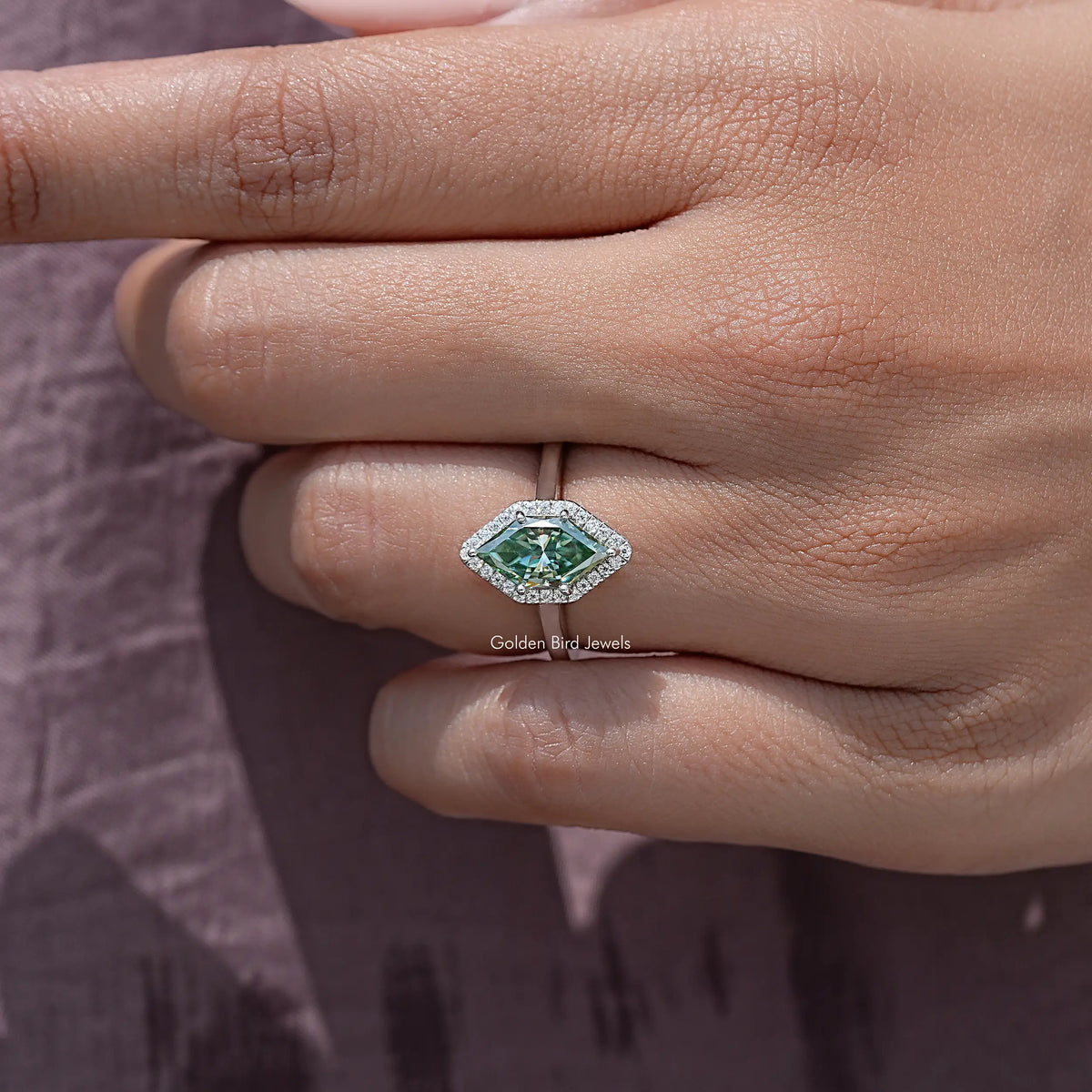Sterling silver marquise moissanite halo wedding ring, side view on fingers