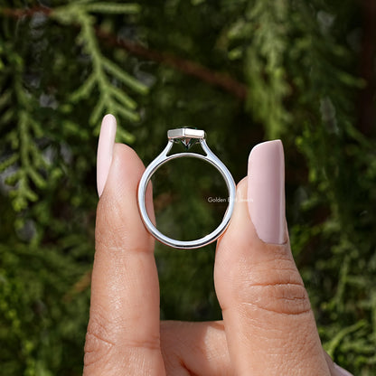 Sterling silver ring featuring a bezel-set green marquise stone viewed straight on