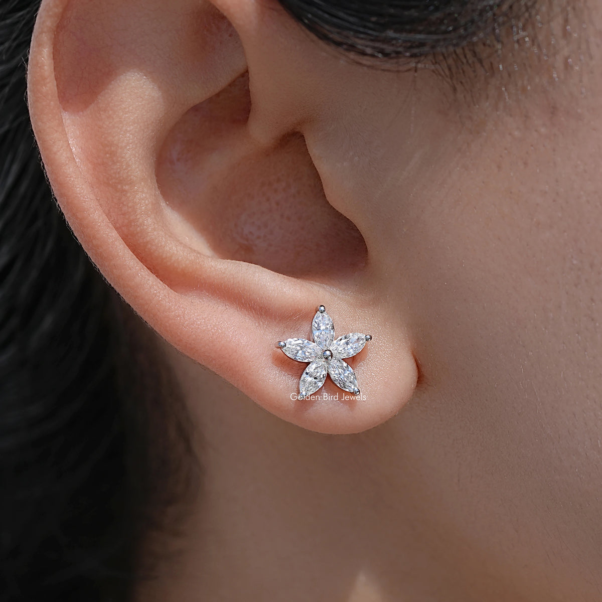Marquise-cut diamond floral stud earrings with flower-shaped star setting