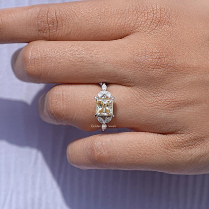 Princess-cut moissanite ring with rectangular center stone and side prongs on hand