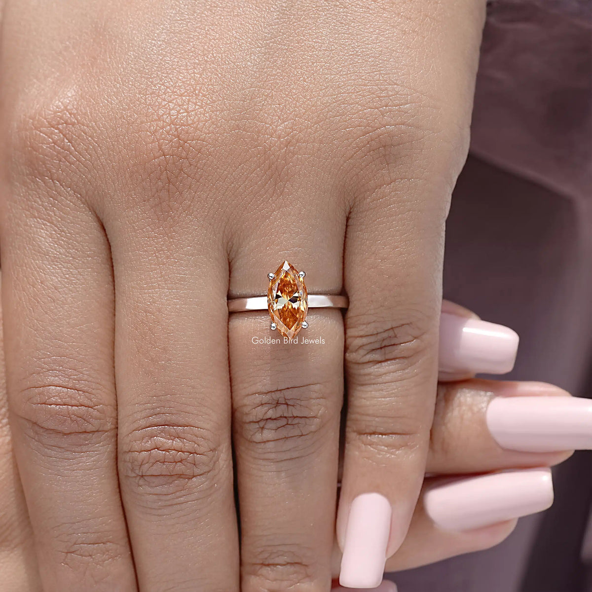 Marquise-cut orange gemstone solitaire ring on silver band