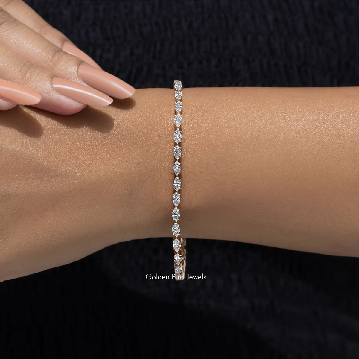 Lab-grown diamond tennis bracelet with marquise-cut stones on wrist, close-up
