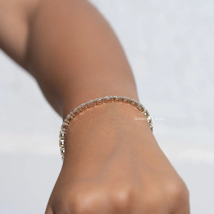 Gold-tone tennis bracelet with marquise-cut diamond stones, side view on wrist