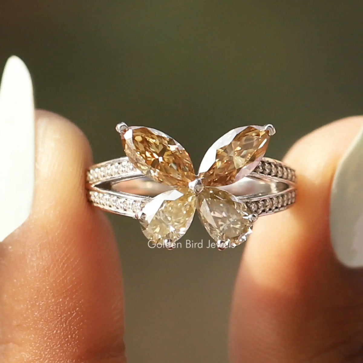 Butterfly engagement ring close-up with marquise stones and prong-set leaf-like accents