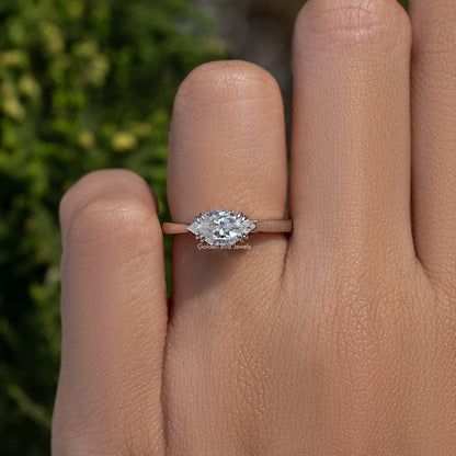 East-west marquise solitaire ring with moissanite center stone on a silver band