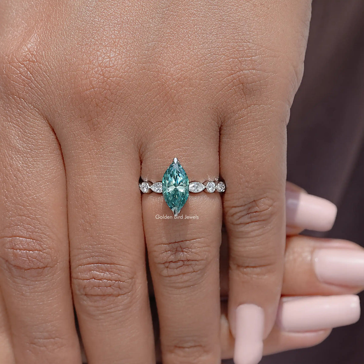 925 sterling silver ring with teal marquise center stone flanked by round diamonds