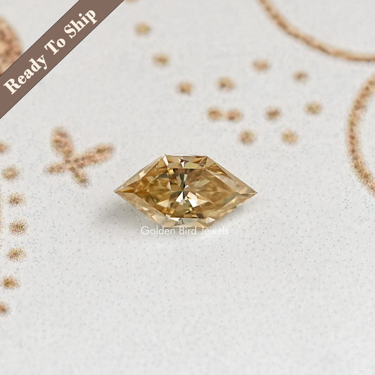 Marquise-cut yellow-gold moissanite gemstone with sharp tips and prismatic facets