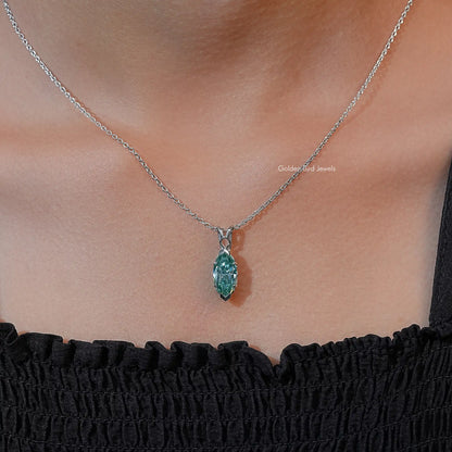 Marquise-cut green solitaire pendant necklace with silver chain, worn with gathered black top