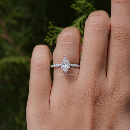 Marquise moissanite solitaire engagement ring on finger, sterling silver band with prongs