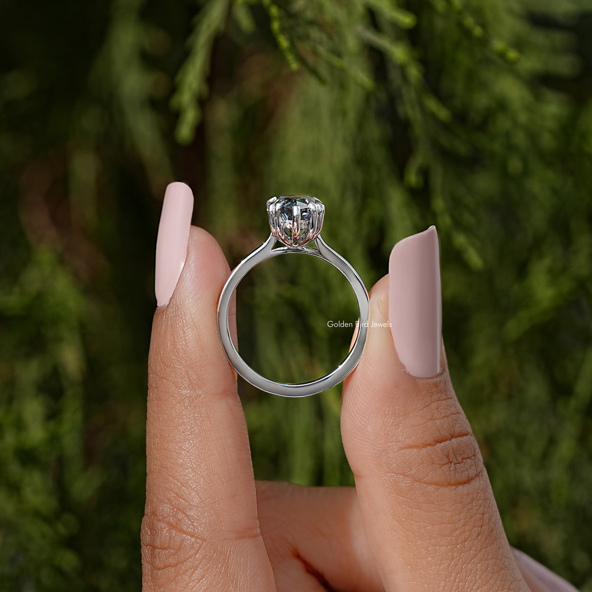 Marquise moissanite solitaire ring, finger view with raised center stone and prongs