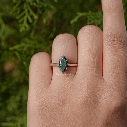 Silver solitaire ring with marquise teal center stone and low profile band