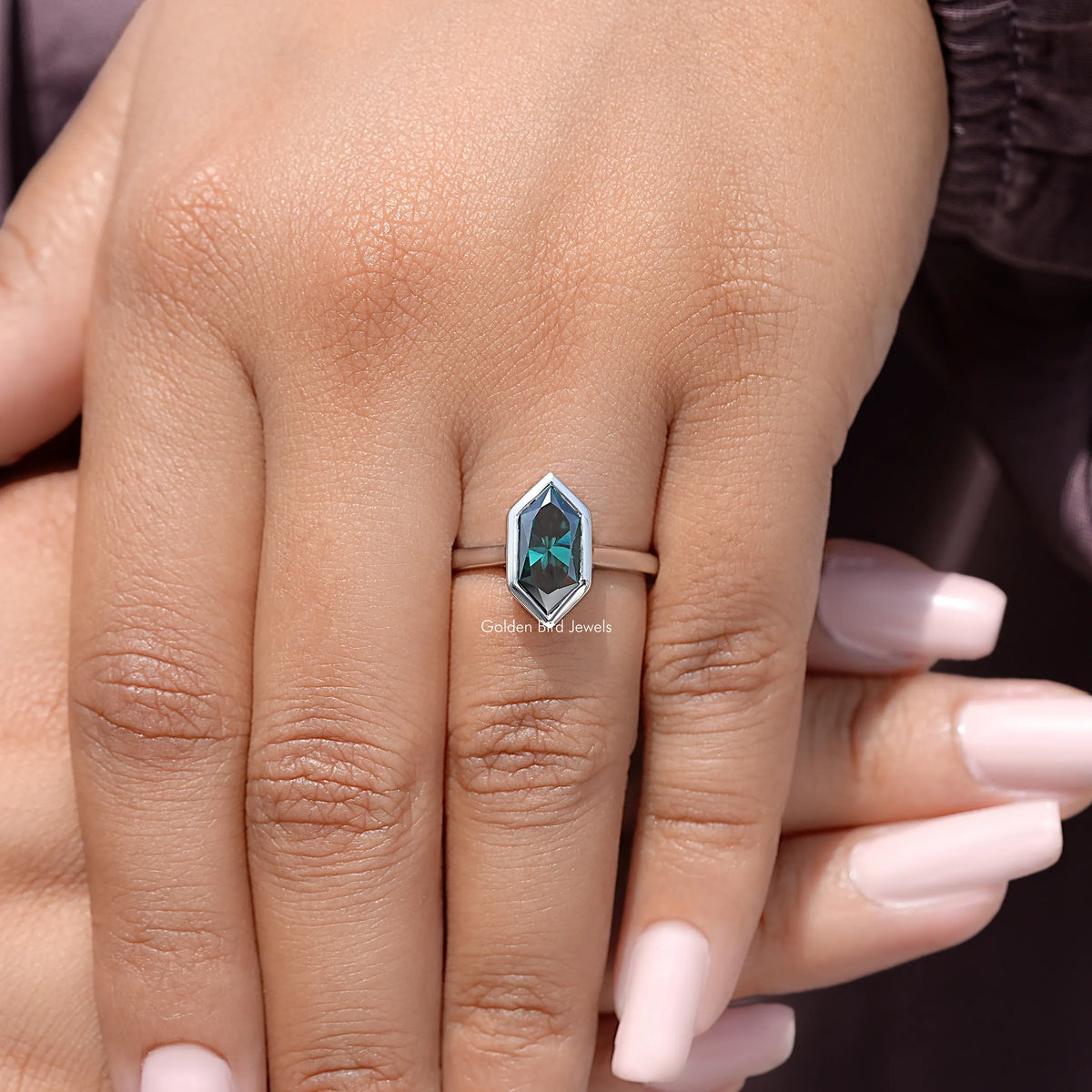 Sterling silver ring with green marquise bezel-cut gemstone on slim band