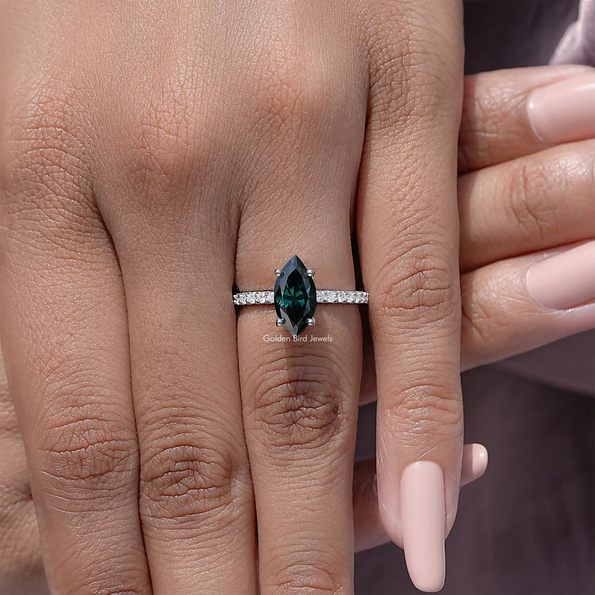 Marquise green moissanite solitaire accent ring with sterling silver band, front view.