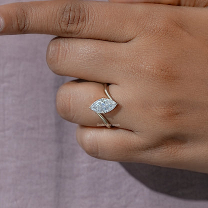 Marquise moissanite solitaire ring close-up on hand with low-profile prongs