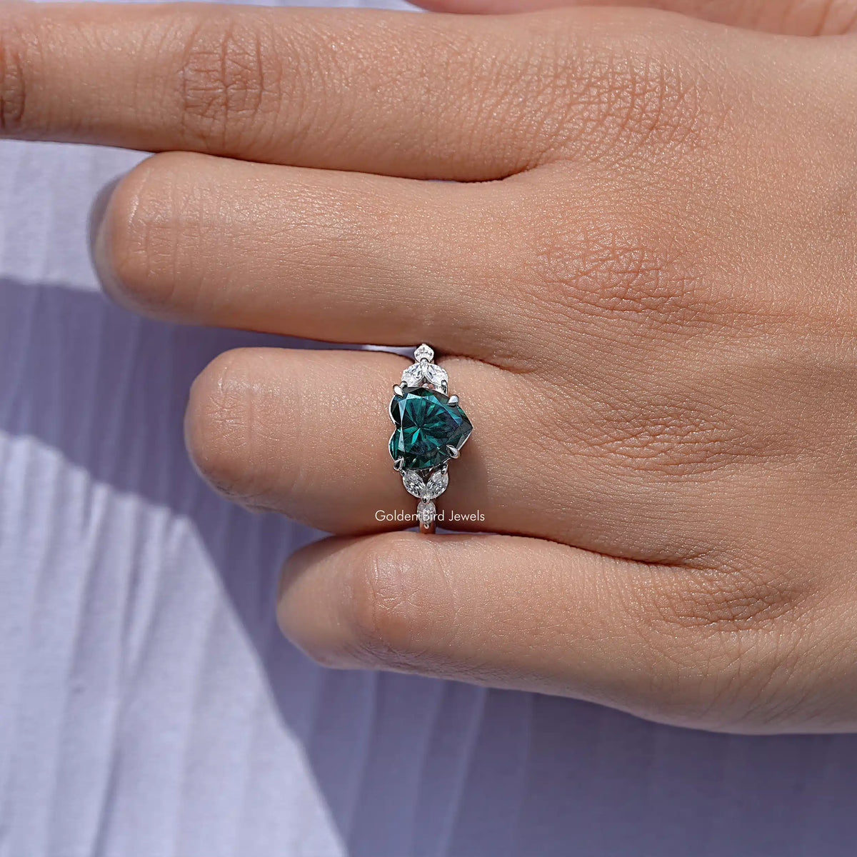 925 sterling silver ring with green moissanite center and prong-set accent stones