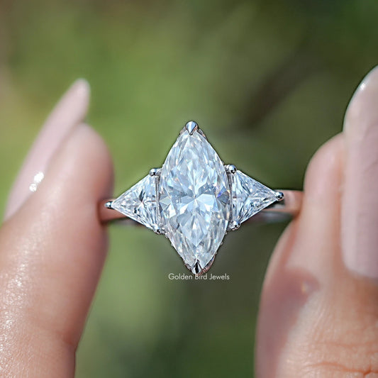 Three-stone moissanite ring with marquise center and two triangle side stones, silvertone.