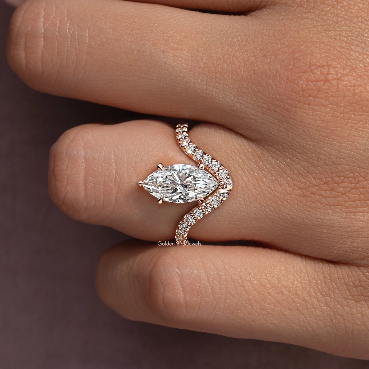 Marquise-cut lab-grown ring with curved pavé accent band on a finger