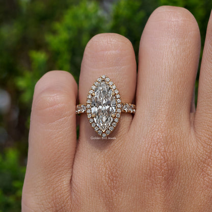 Marquise-cut center halo engagement ring with round accent shoulders, close-up