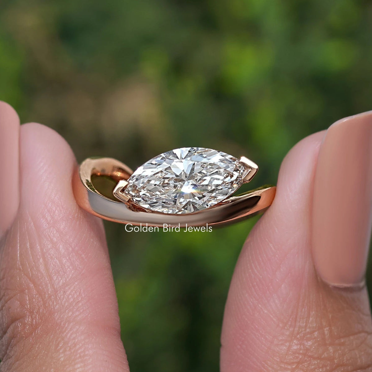 Rose-gold marquise-cut lab diamond curved solitaire ring on fingers