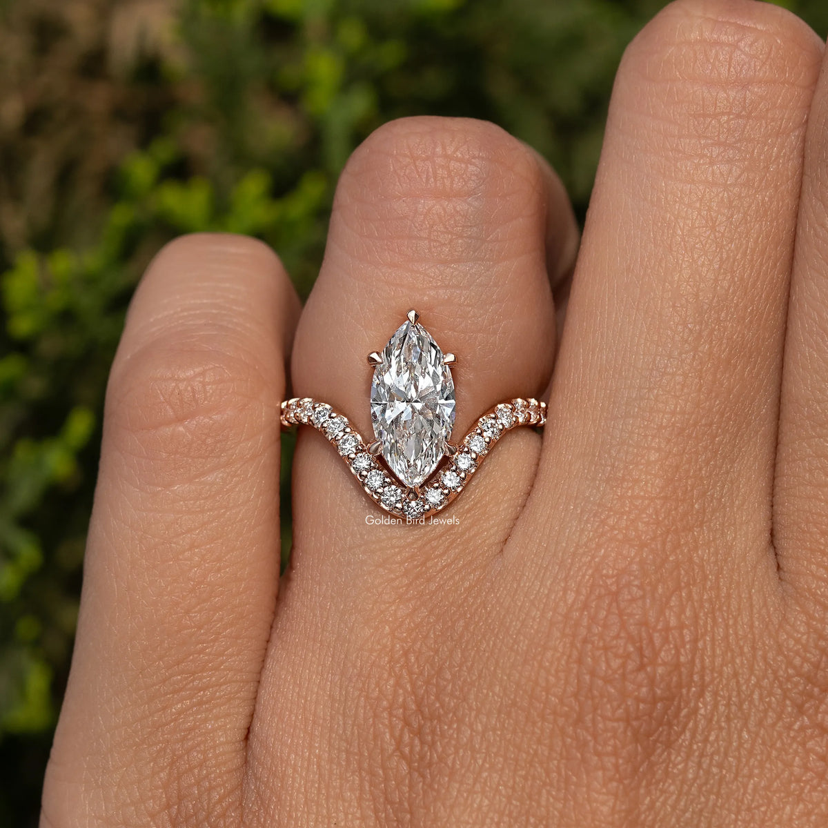 Gold-tone marquise-cut diamond ring with curved halo-like side stones