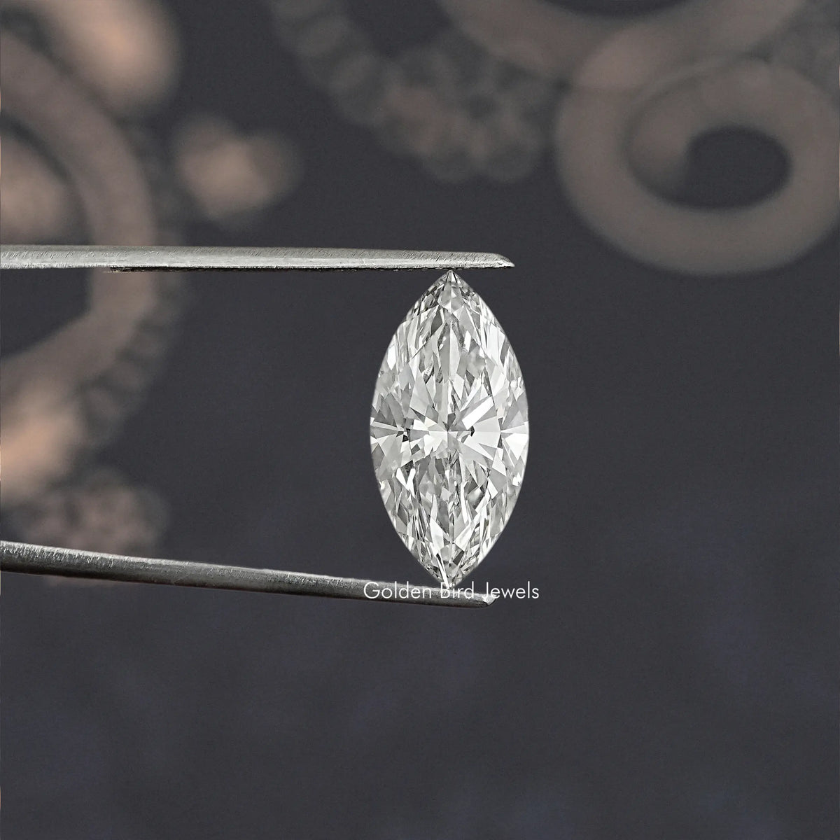 Loose marquise-cut lab diamond held between metal tweezers, bright faceted sparkle