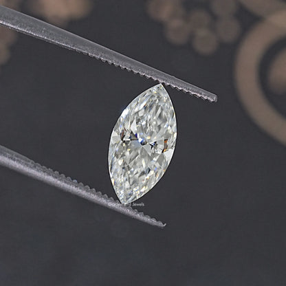 Pear-shaped moissanite loose stone, clear faceted gem between tweezers