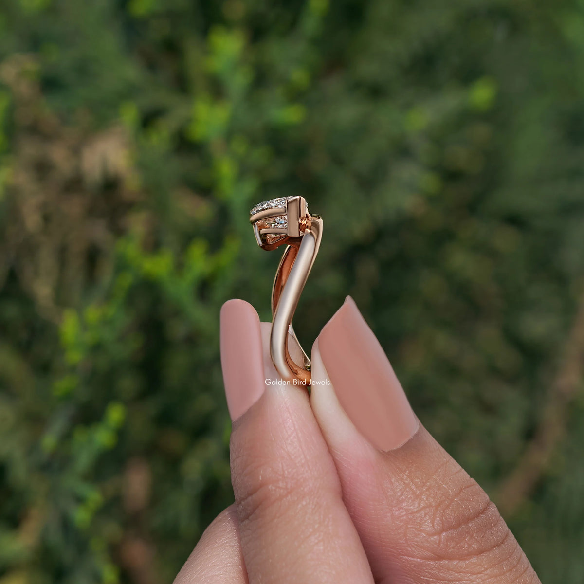 Rose-gold curved solitaire ring with marquise-cut lab diamond, side view