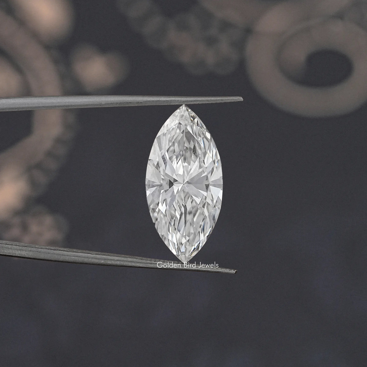 Marquise-cut loose lab-grown diamond held on metal tweezers, bright white sparkle