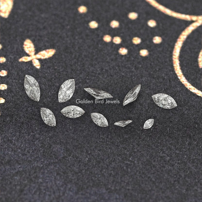 Marquise-cut lab-grown diamonds, scattered loose marquise stones on dark display