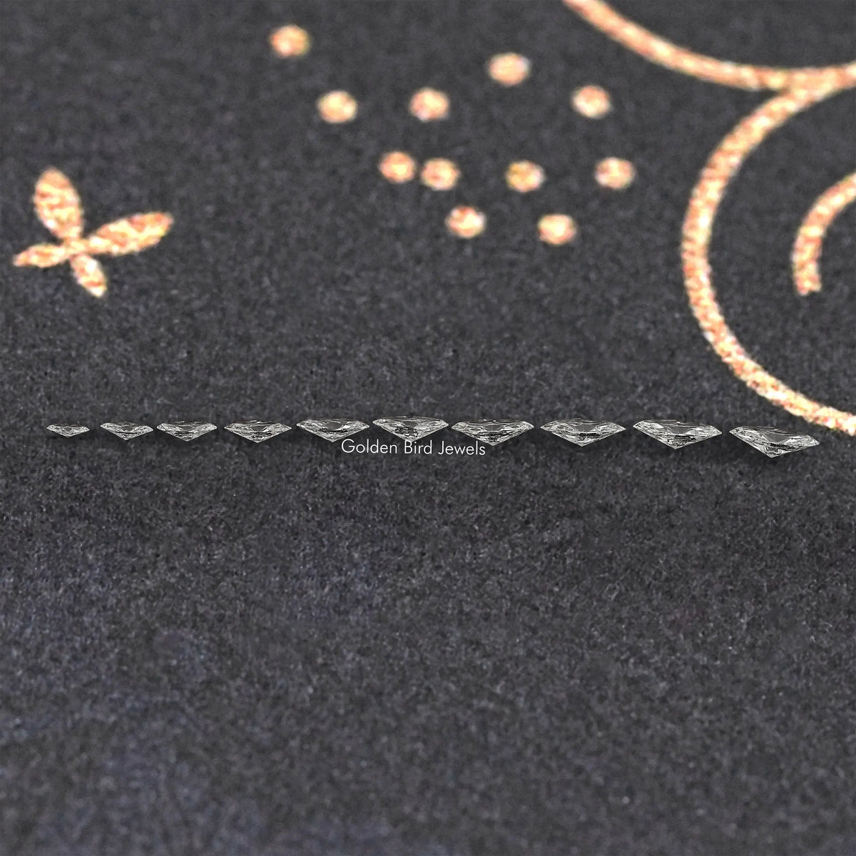 Marquise-cut lab diamonds in a straight row on dark fabric display