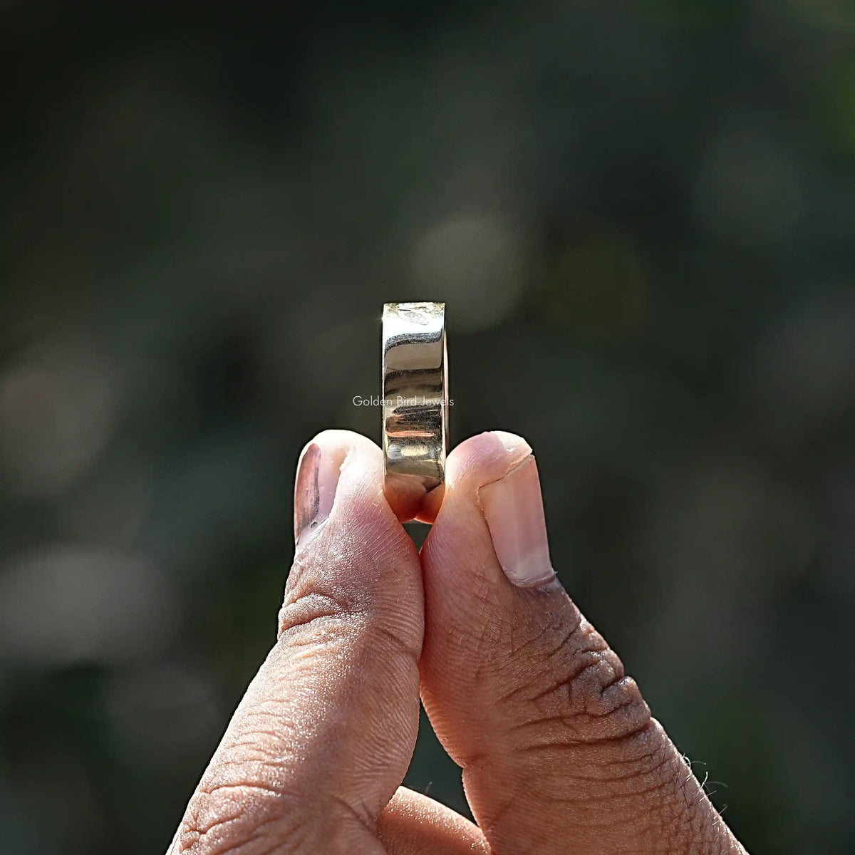 Side View of A Marquise And Round Cut Ring In two fingers