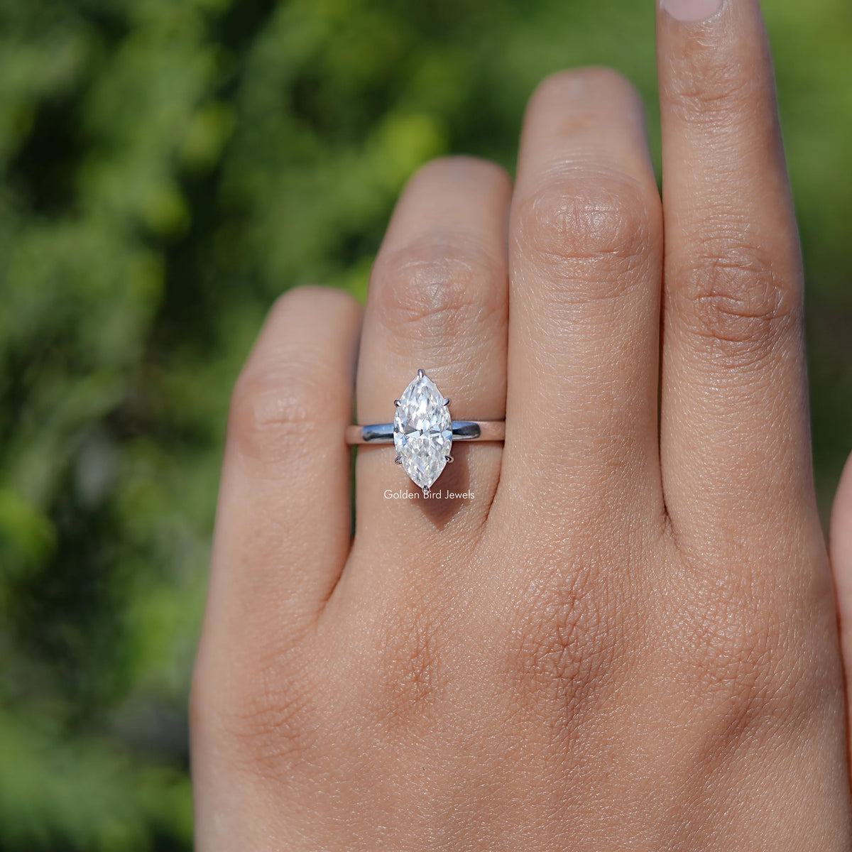 In finger front view of Marquise Cut Moissanite engagement ring 
