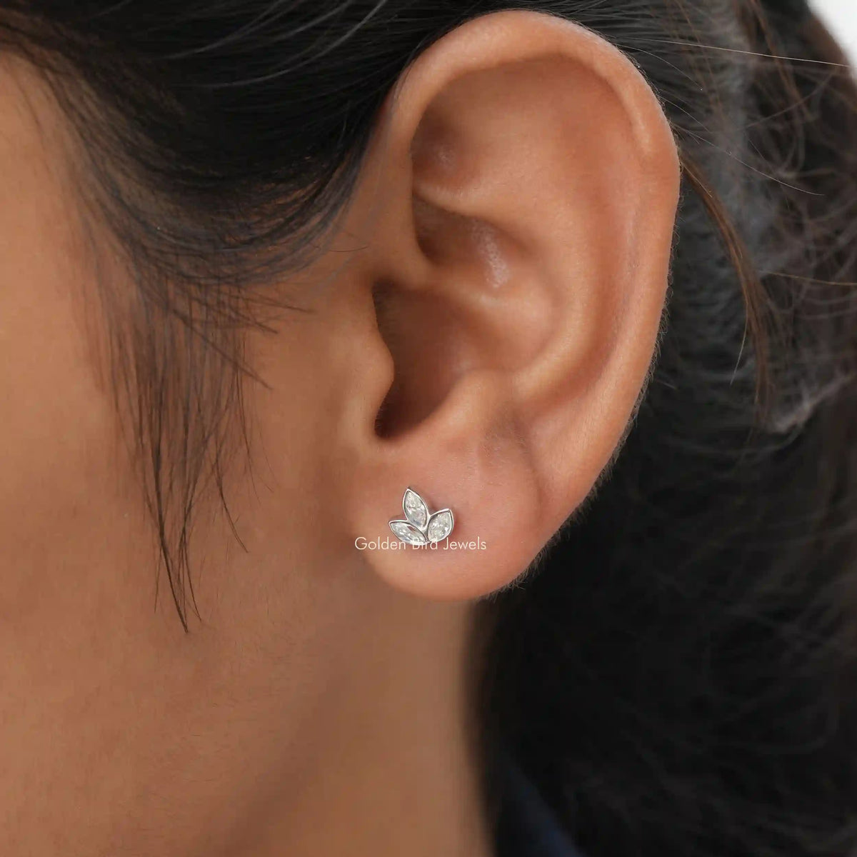 Detailed view of stud earings in secure setting 