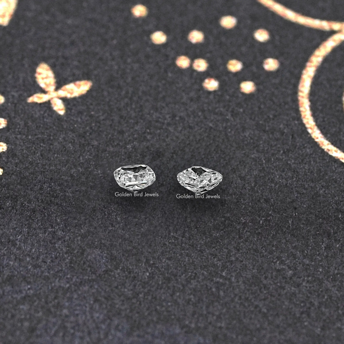 Cushion-cut lab grown diamond stud pair, two square-cut stones on dark fabric