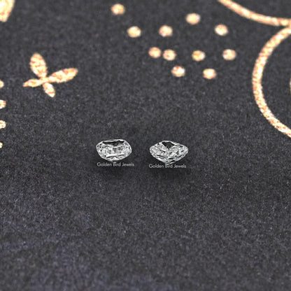 Cushion-cut lab grown diamond stud pair, two square-cut stones on dark fabric