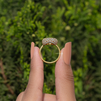 Yellow-gold halo engagement ring showing round pave shank, centered on finger
