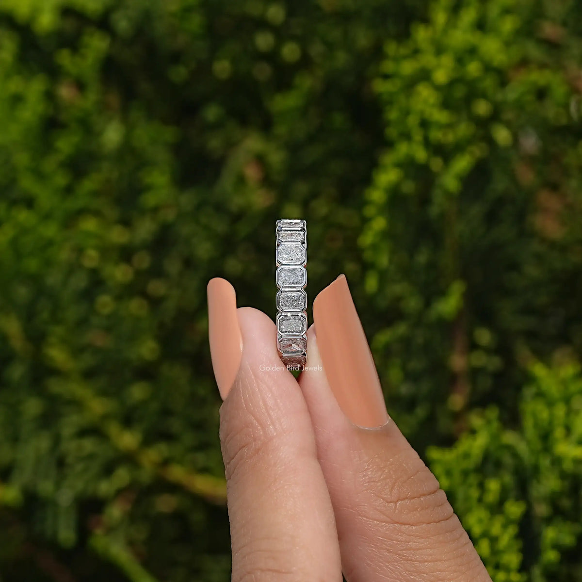 Silver eternity band ring with bezel-set square stones, slim stacked look