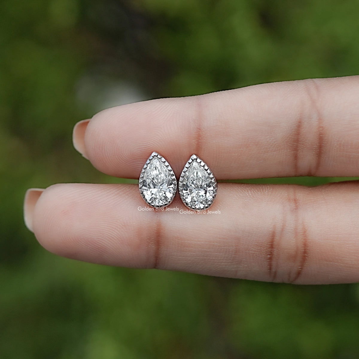 In Hand View Of Pear  Cut Lab Diamond Bezel Studs