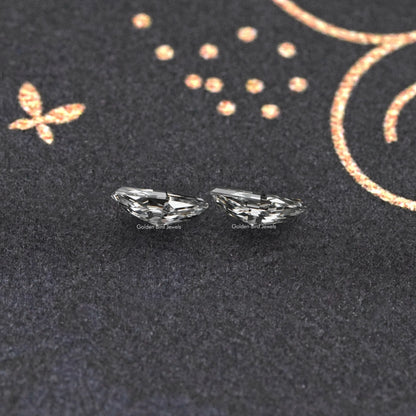 Modified lozenge-cut lab-grown diamond stud earrings, side view of clear faceted stones