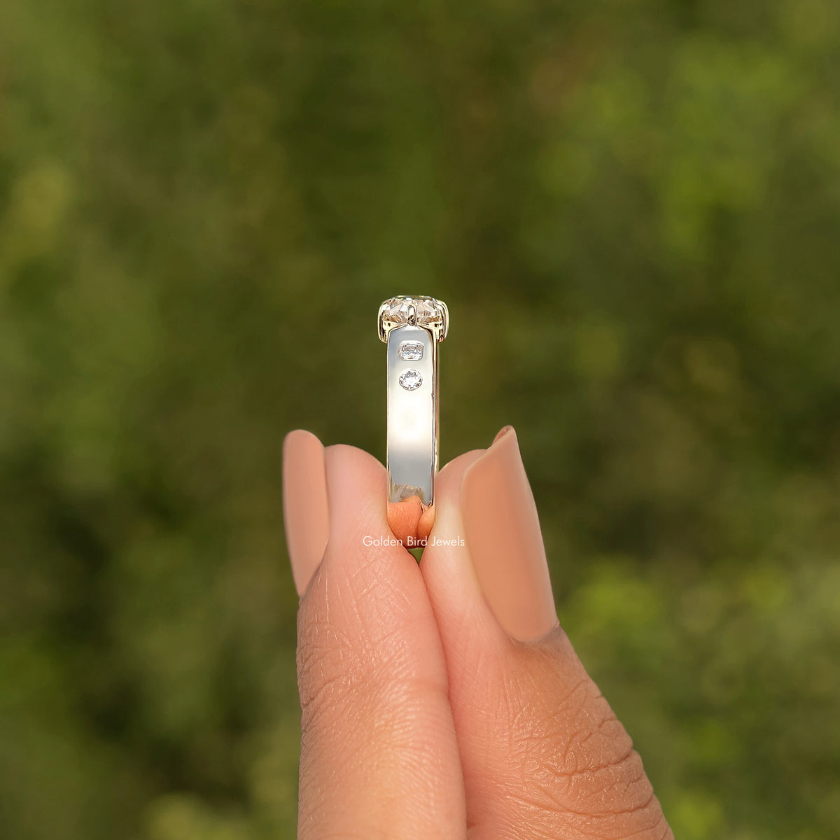 Gold moissanite ring with rectangular setting and small round center stone