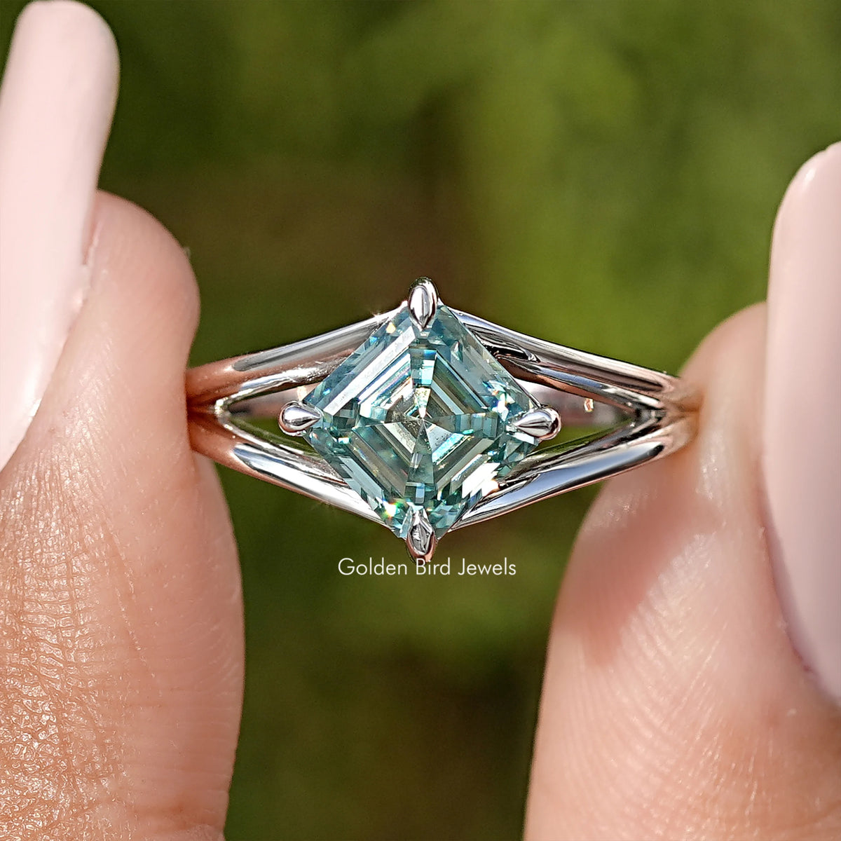 Asscher cut moissanite split shank ring in sterling silver, teal stone front view