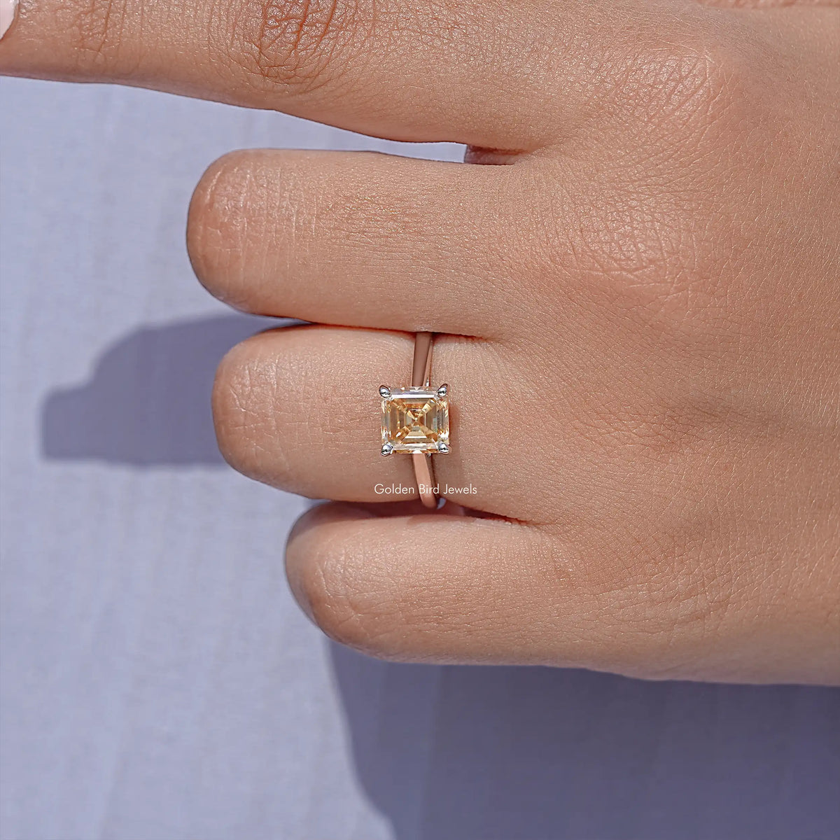 Asscher-cut moissanite solitaire ring in sterling silver, close-up on the square gemstone.