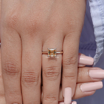 Sterling silver Asscher-cut moissanite solitaire ring on finger, four-prong square center.
