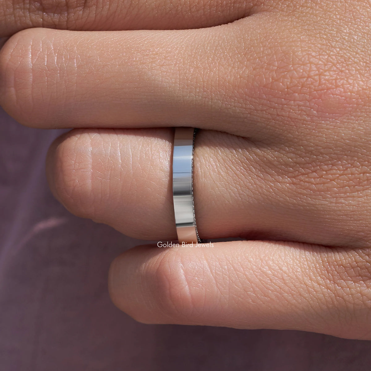 Silver-tone channel-set ring band with small round stones, side view